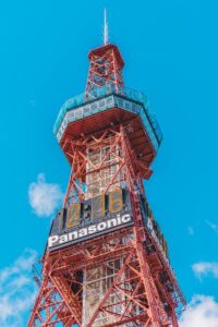 a tall tower with a sign on top of it