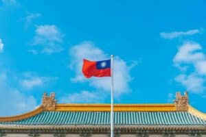 a red and blue flag on top of a building